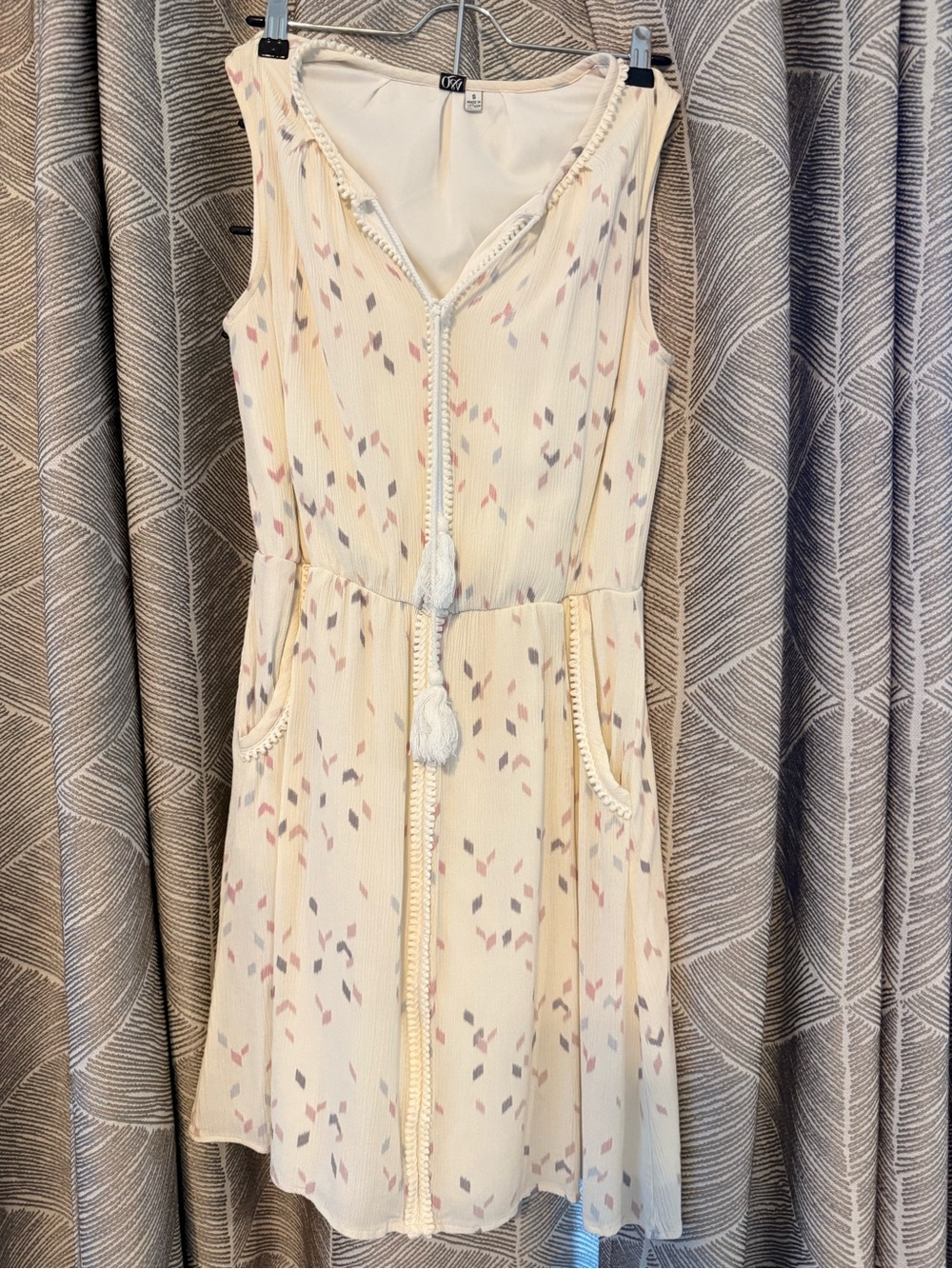 Sleeveless Cream Tassel Tie Mini Dress with Subtle Print